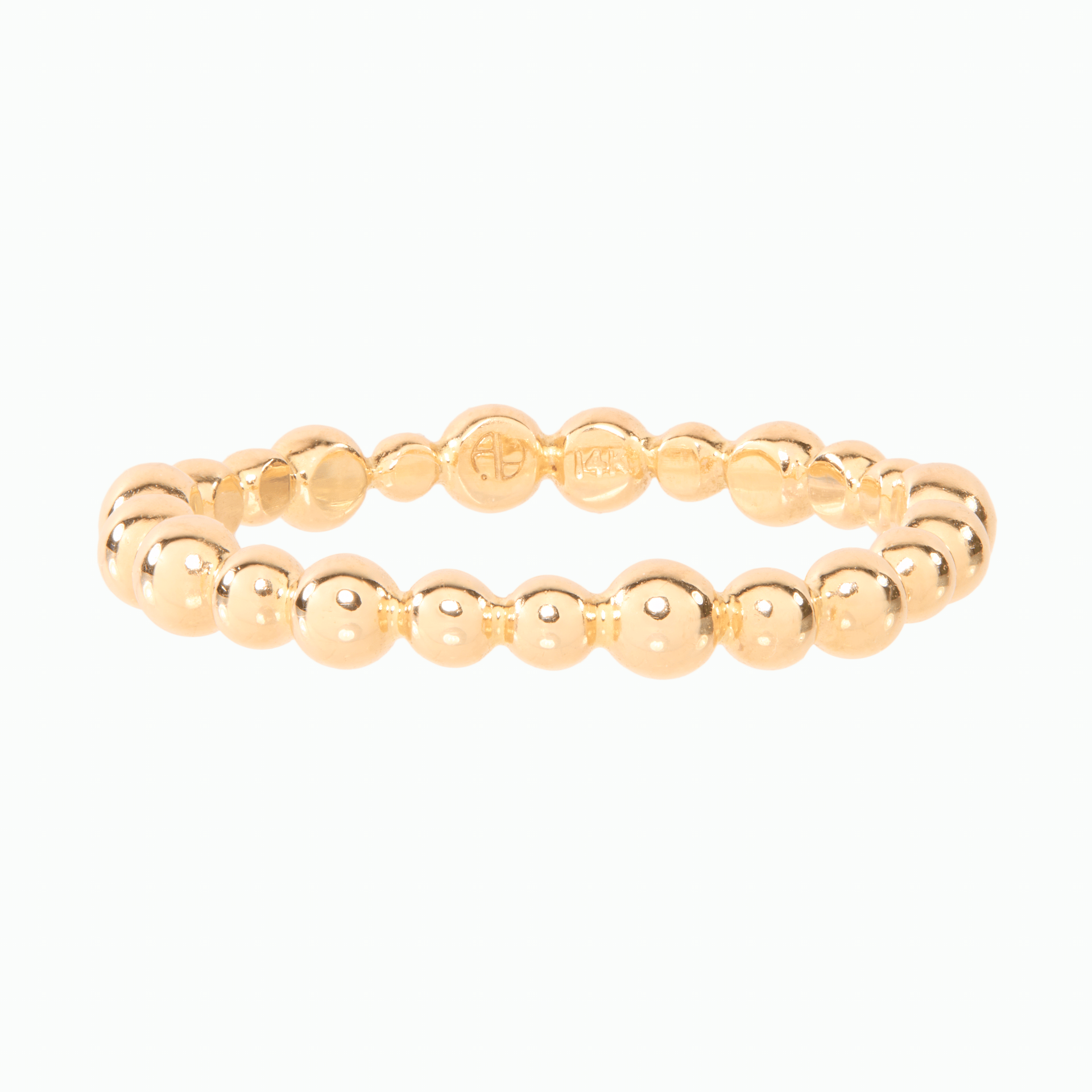 Gold beaded ring on a white background