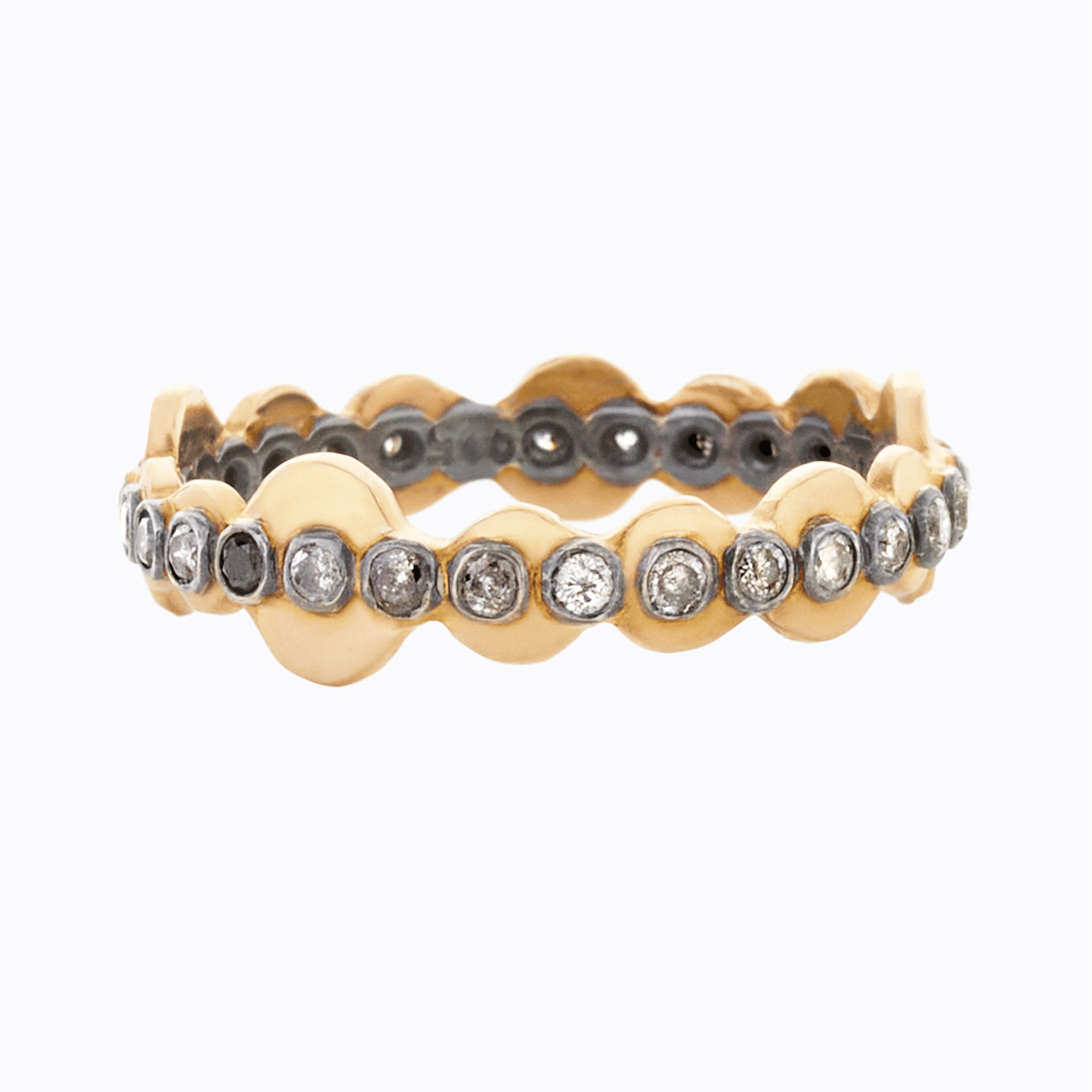 Gold and silver ring with diamond accents on a white background