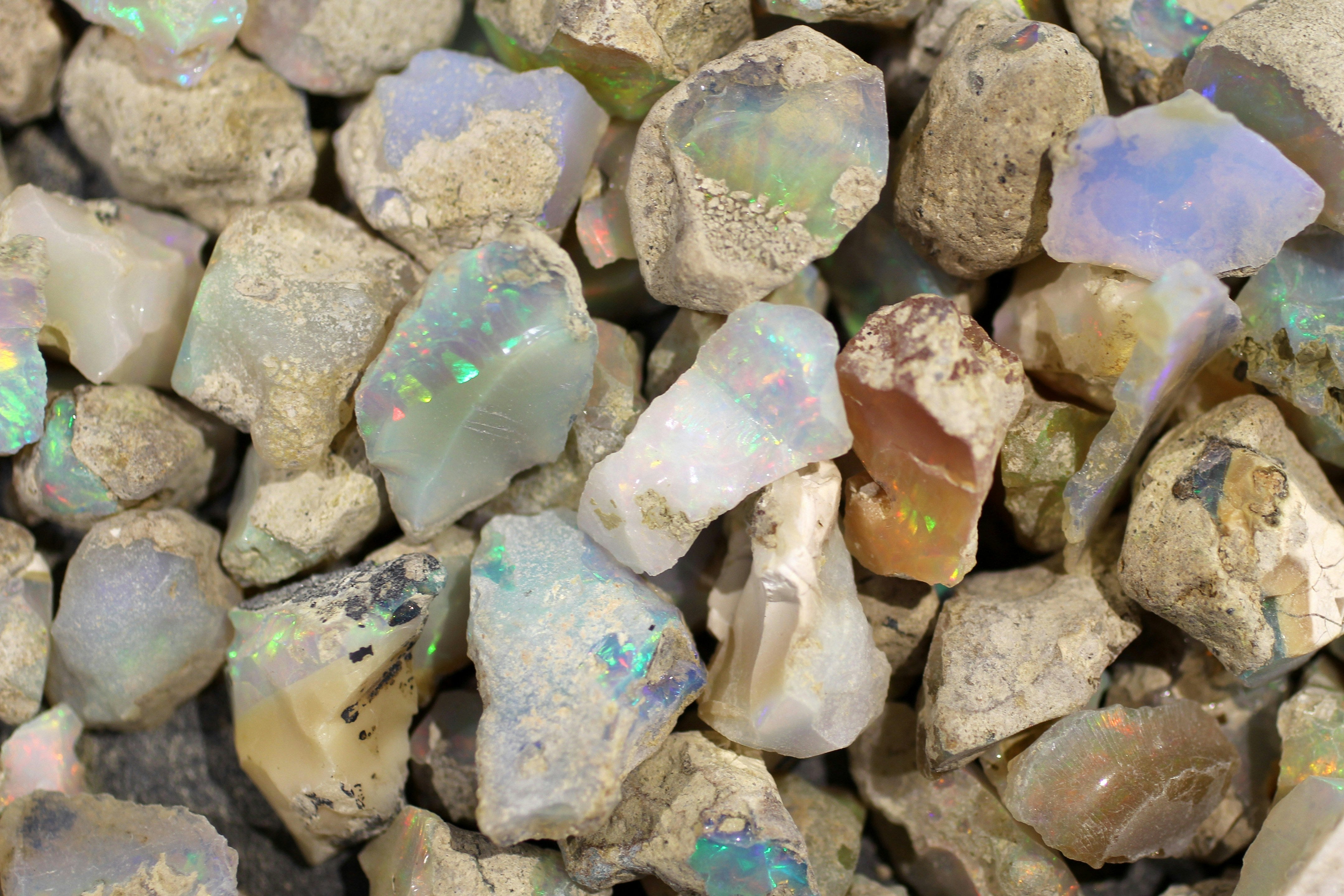 Close-up of raw opal stones with iridescent flashes.